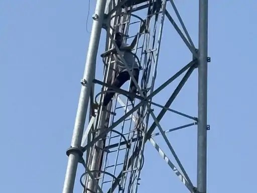 young man climbed the tower